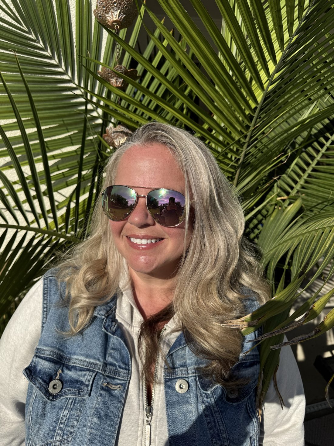Sarah Burkeen smiling in her aviator sunglasses